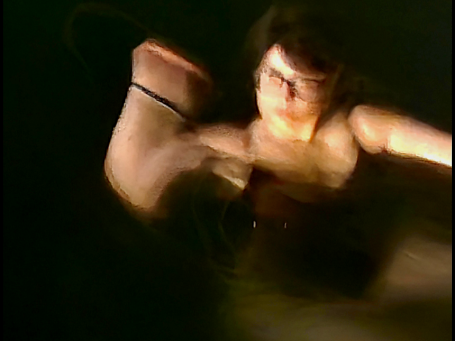 Close detail of hands and shoulders at night, camera movement turning skin into pigment
